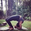 A person doing yoga in the grass