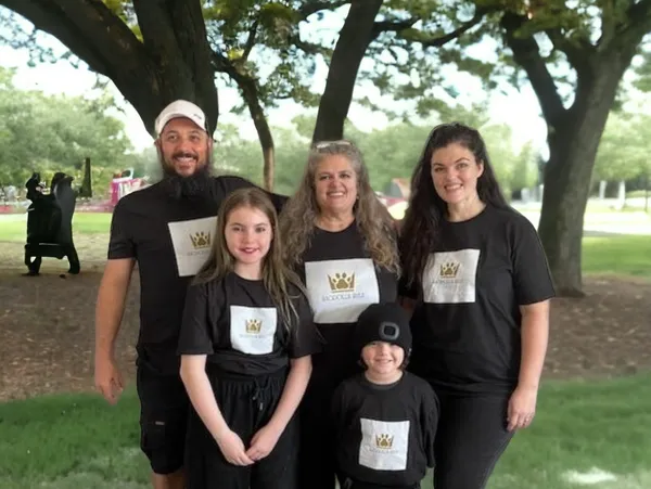 A family wearing matching black and white shirts.