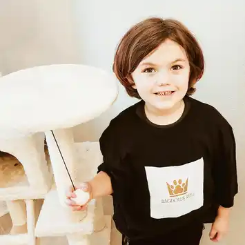 A young child holding a remote control.