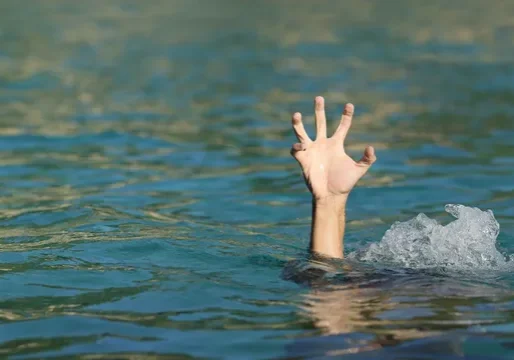 A hand is reaching out of the water.